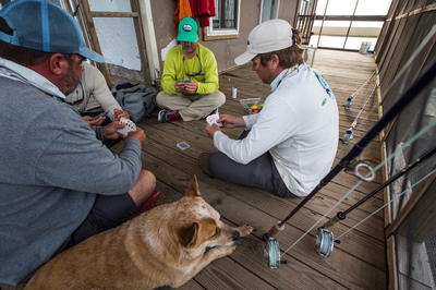 Redfish Dynasty fly fishing guides play cards after a long day ofmfly fishing in Louisiana