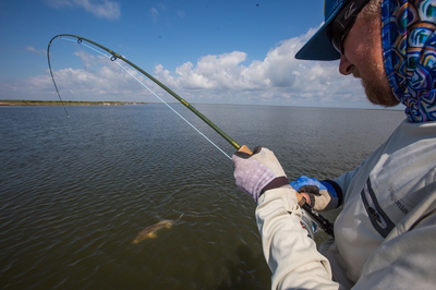 fighting a big Louisiana red fish on fly while fishing withe the best guides in Louisiana